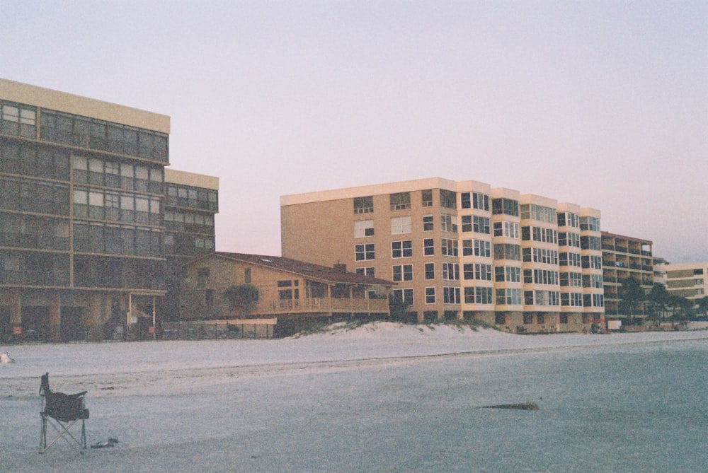 a couple of buildings sitting next to each other on a beach