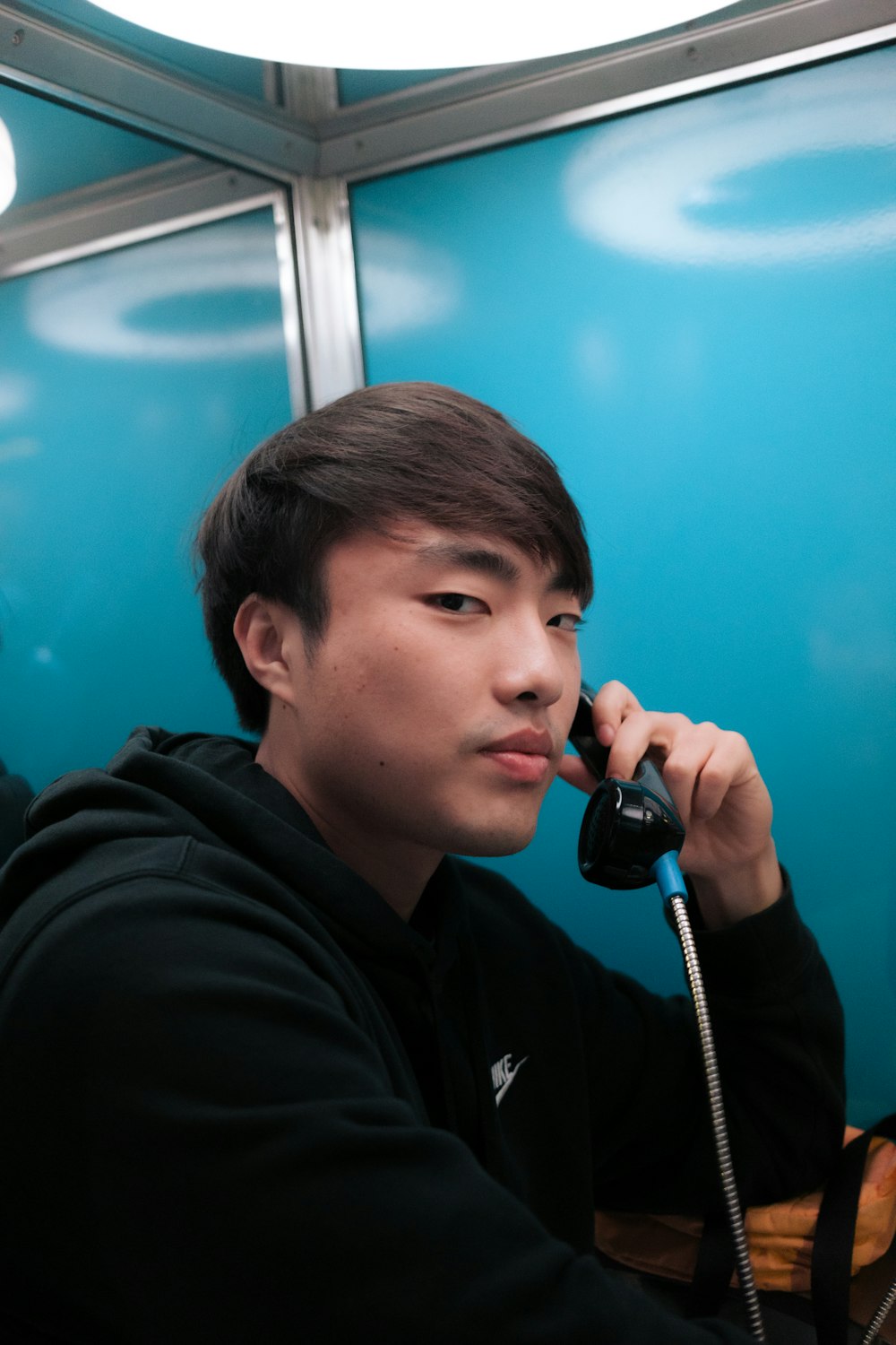 a man talking on a phone while sitting down