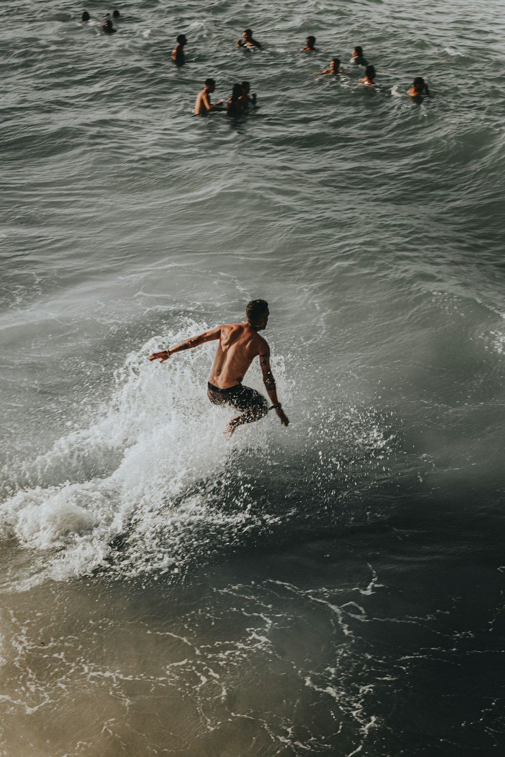 a man riding a wave on top of a surfboard