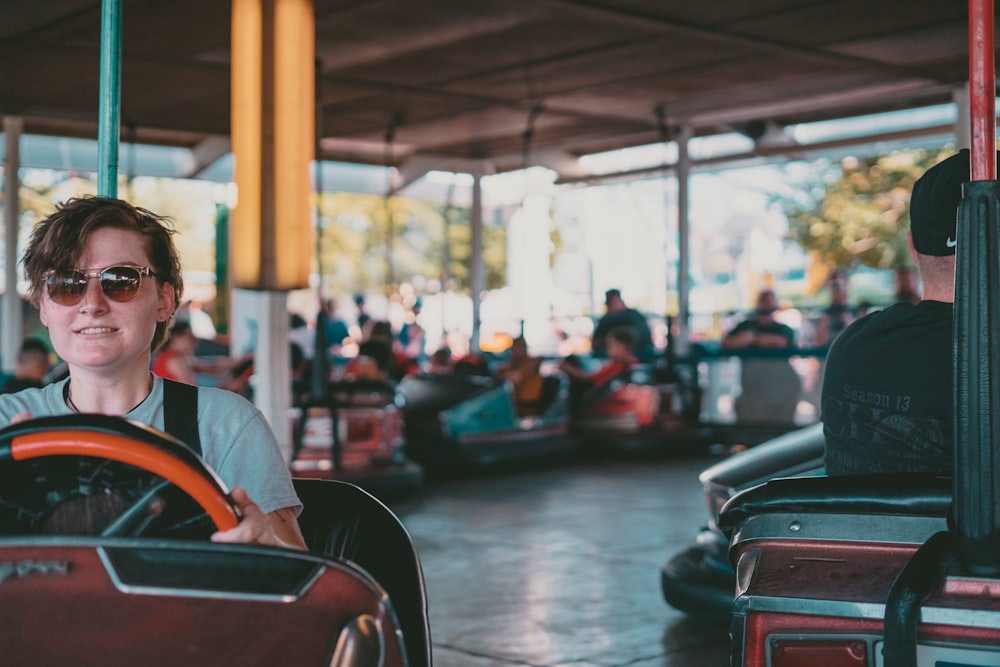 a woman driving a car at a carnival