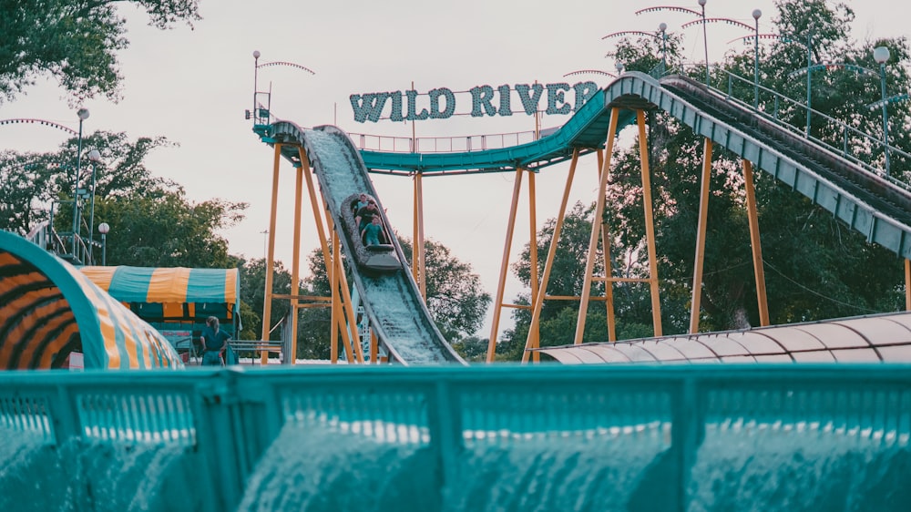 a roller coaster going down a hill in a theme park