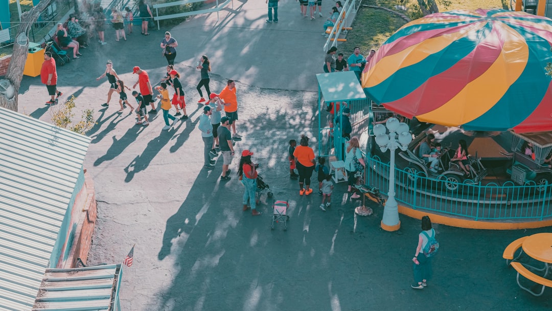 People walk past a colorful building at a theme park