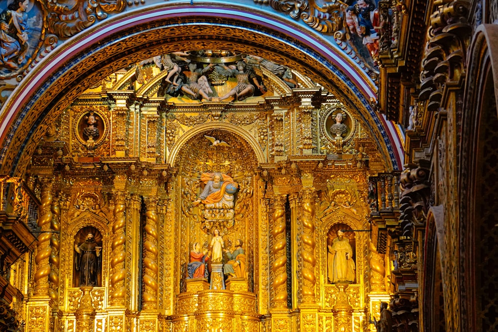 a very ornate gold alter in a church