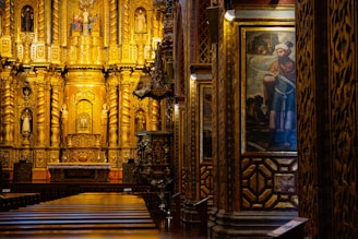 a church with a golden alter and paintings on the walls