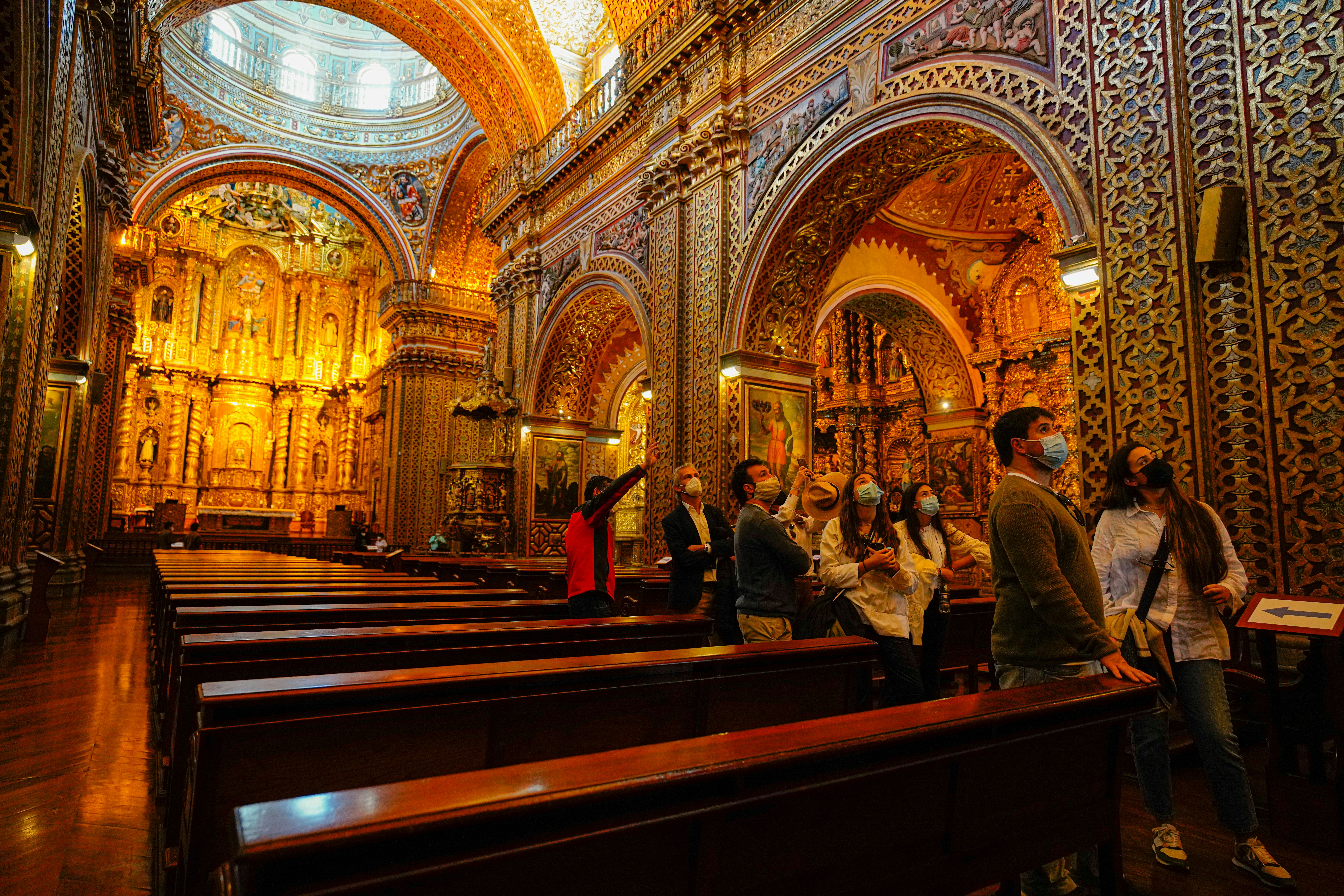 a group of people standing inside of a church