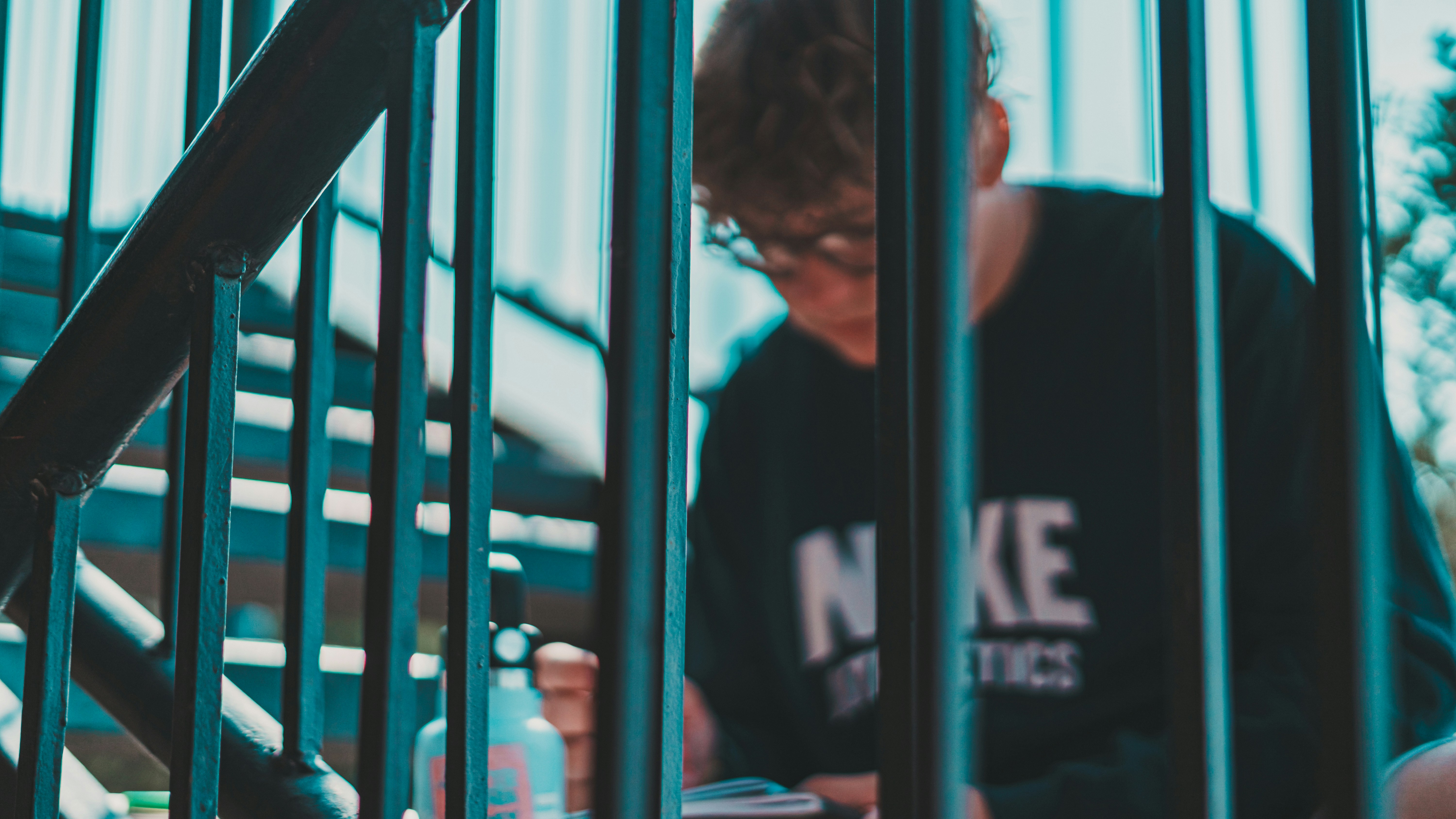 a man sitting on a bench next to a set of stairs