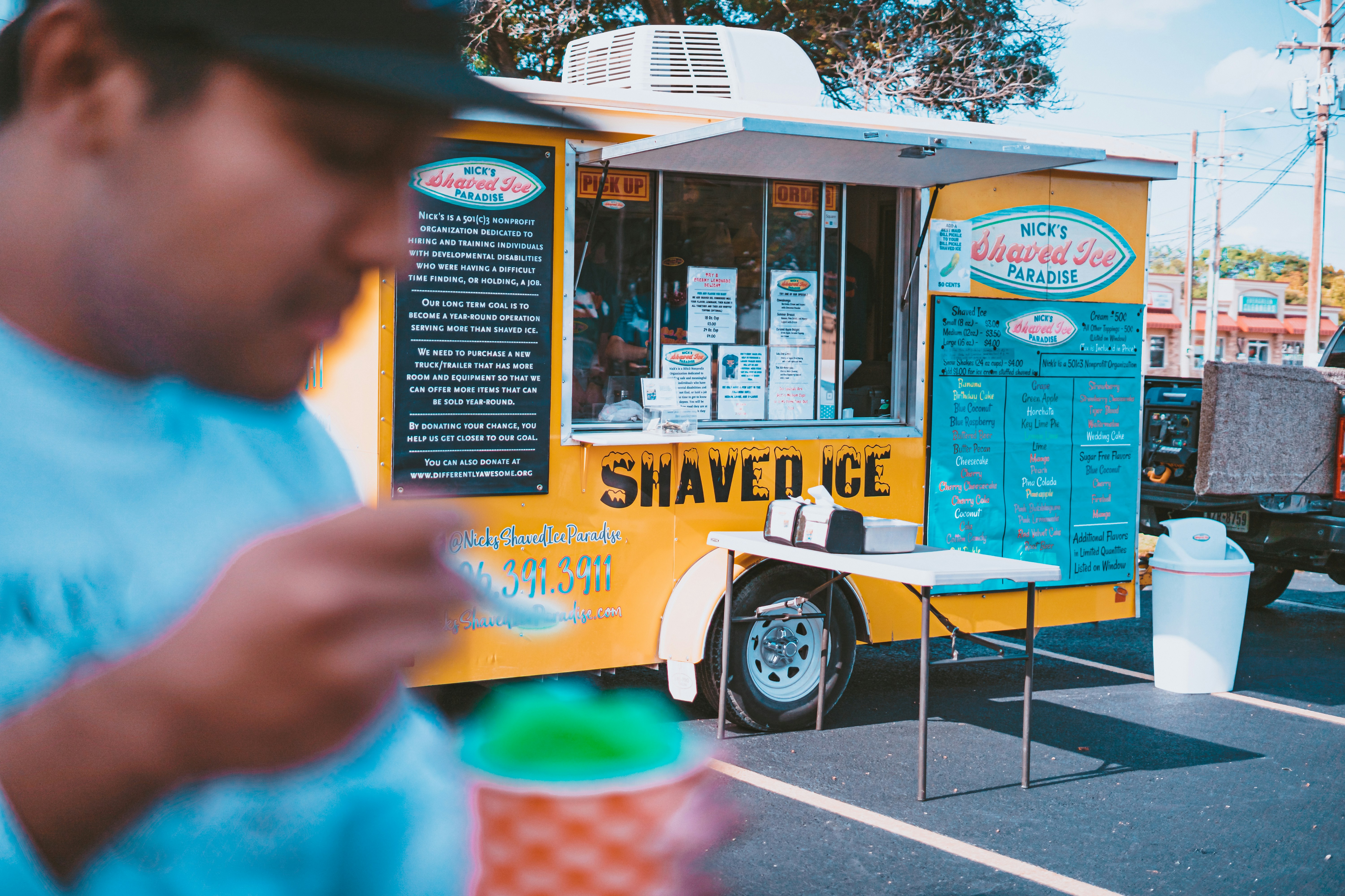 Ice cream vendor scooping grassfed ice cream from a food truck in Houston