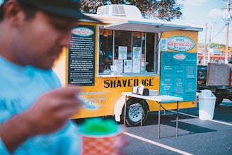 a man standing in front of a food truck
