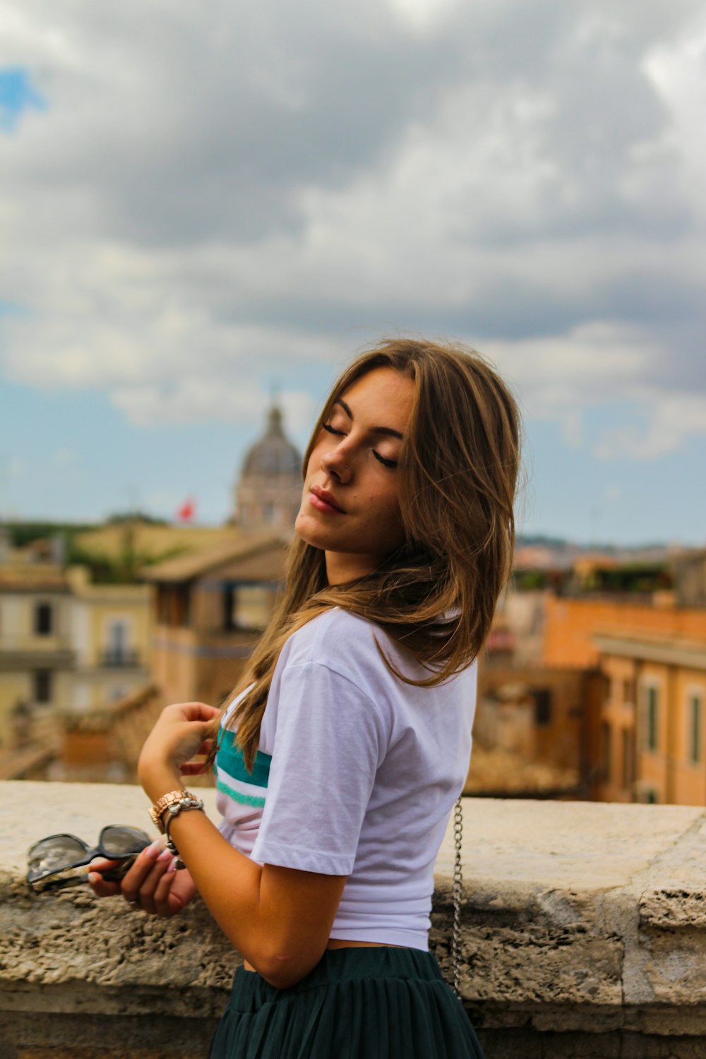 a woman in a white shirt and a green skirt