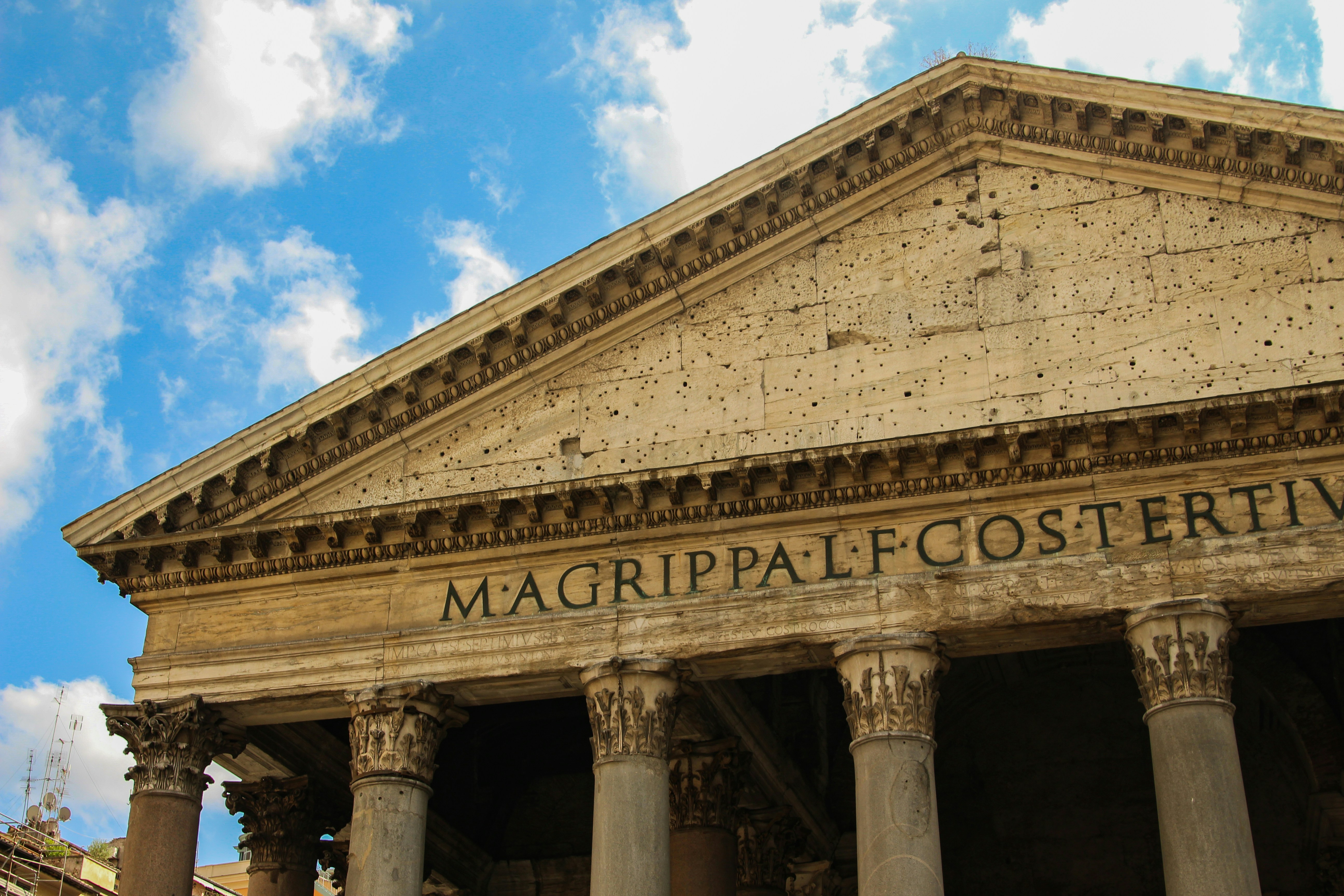 a large building with columns and a sky background