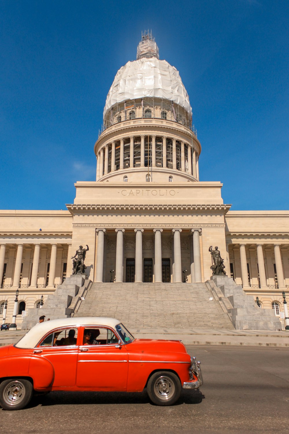 a red car parked in front of a building