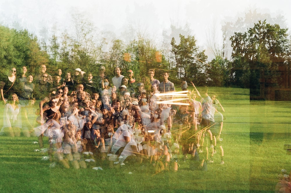 a group of people standing on top of a lush green field