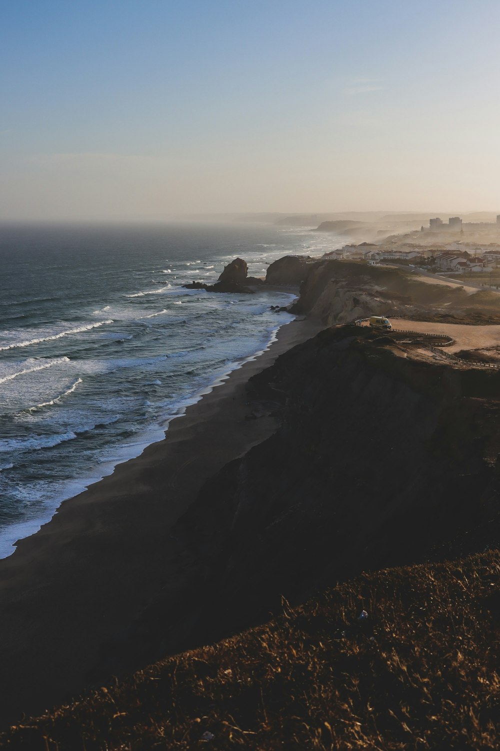 a view of the ocean from the top of a hill