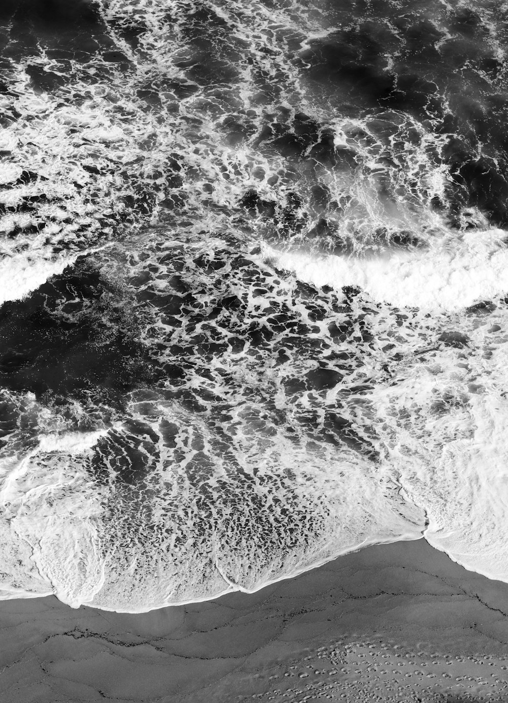 a black and white photo of the ocean waves