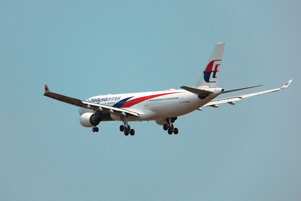 a large jetliner flying through a blue sky