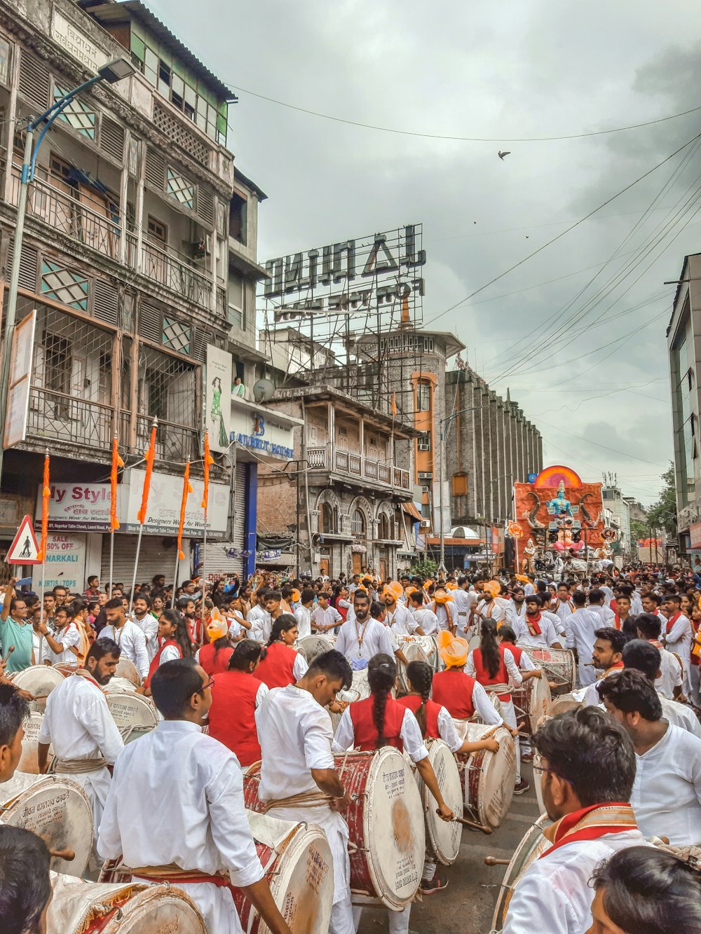 a large group of people playing drums in the street