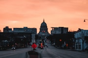 a city street at sunset with a dome in the background
