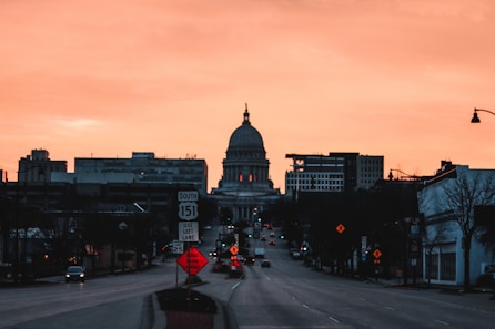 a city street at sunset with a dome in the background