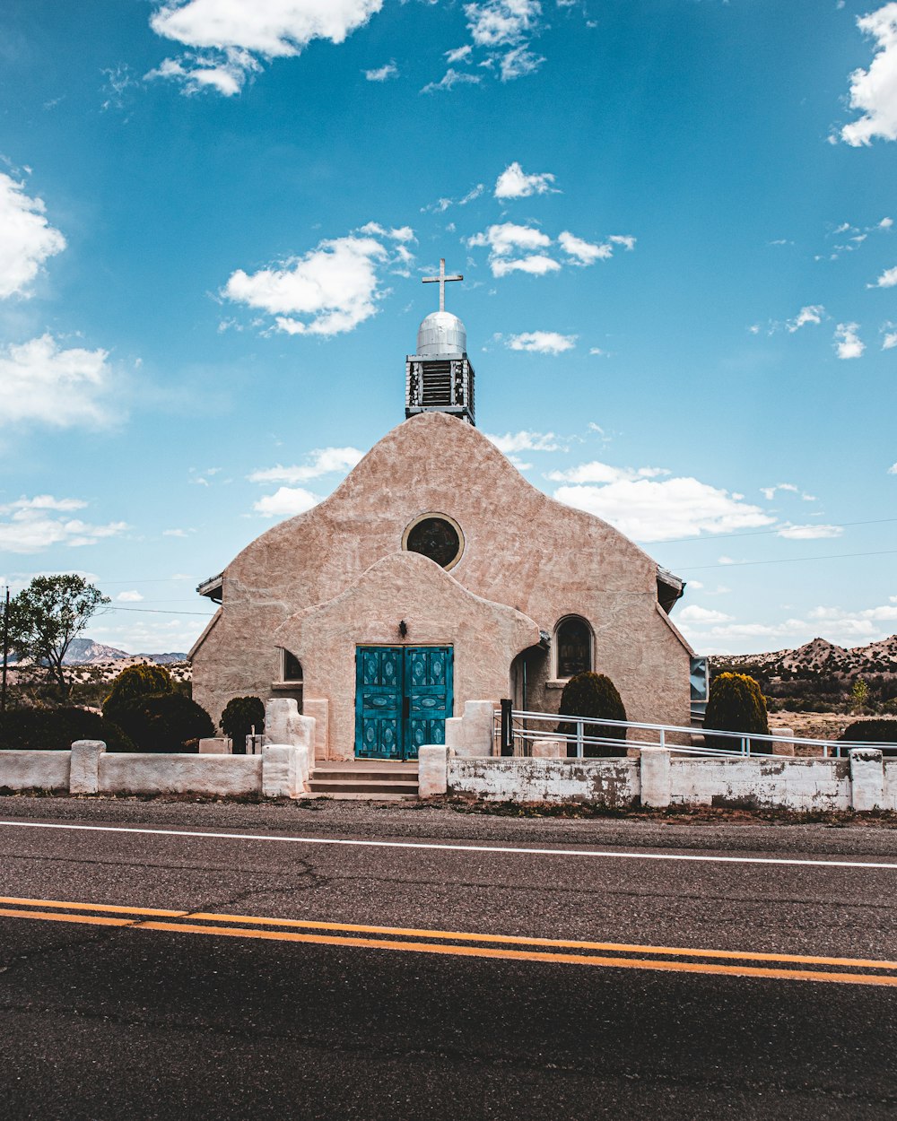 a church with a blue door and a steeple