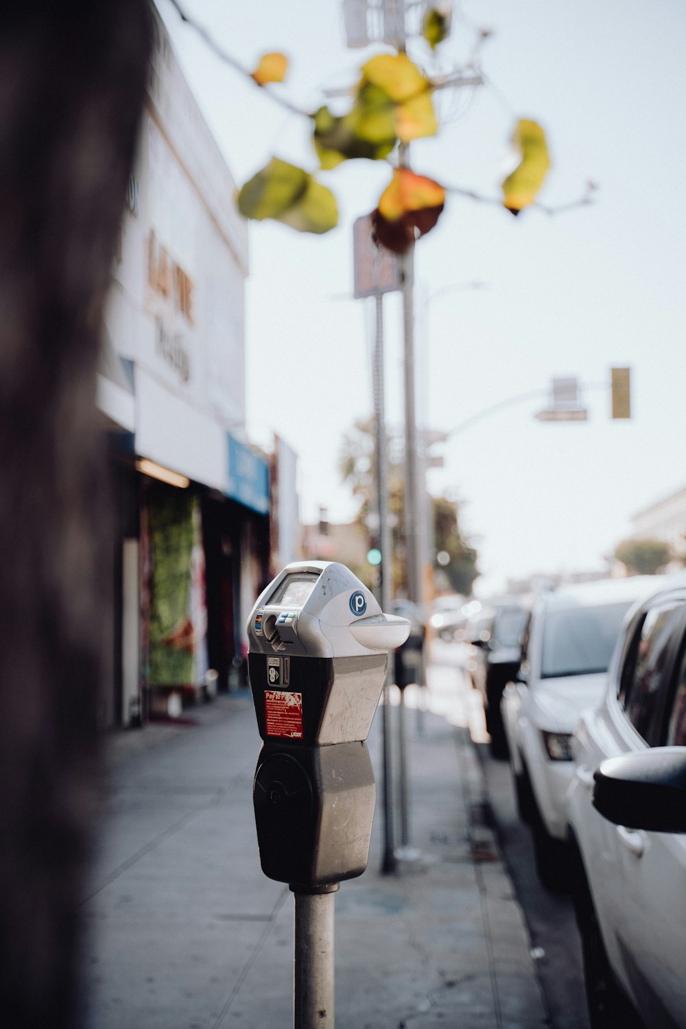 a parking meter sitting on the side of a street