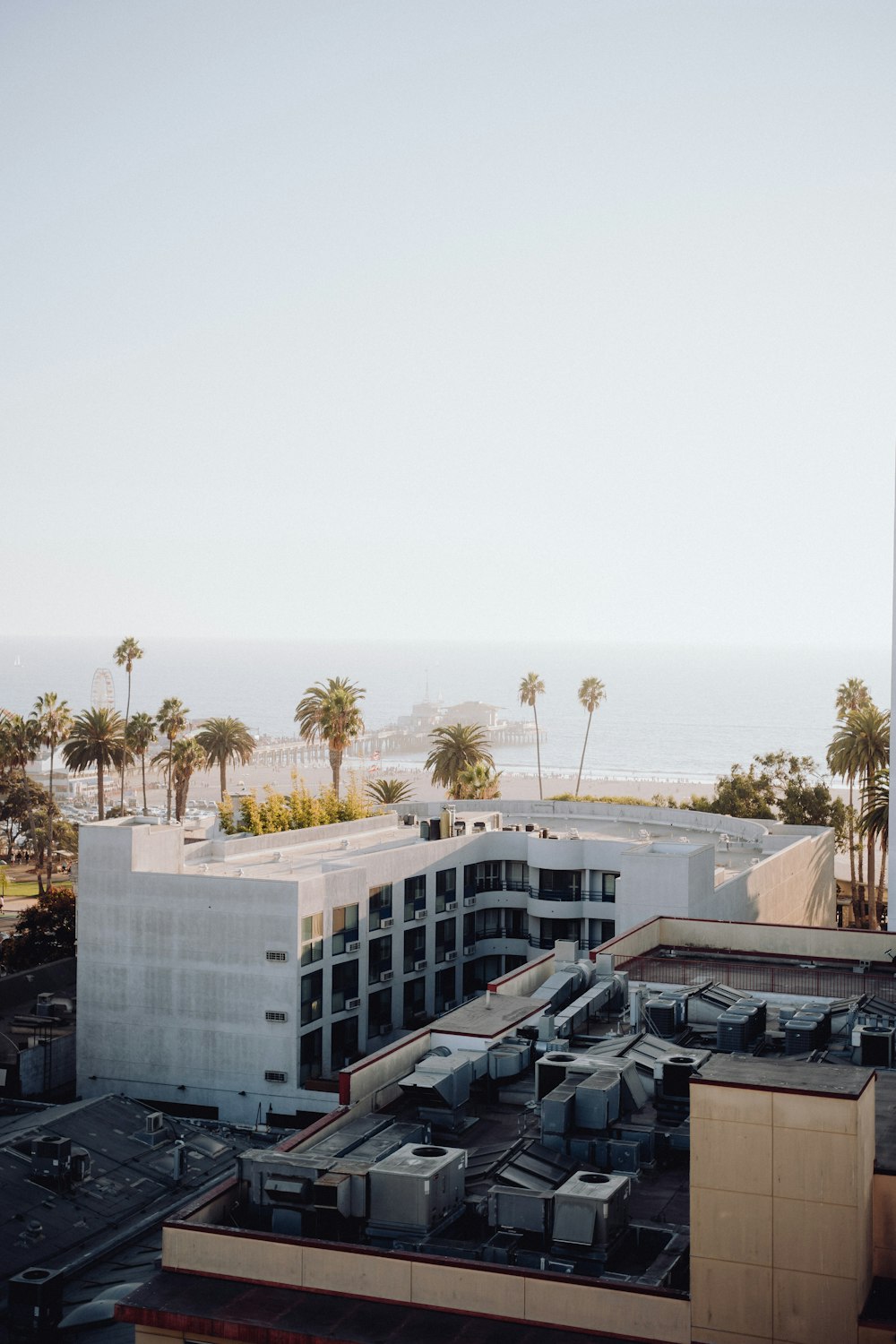 an aerial view of a building with a beach in the background