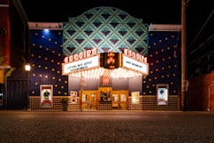 a theater building with a marquee lit up at night