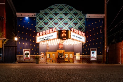 a theater building with a marquee lit up at night