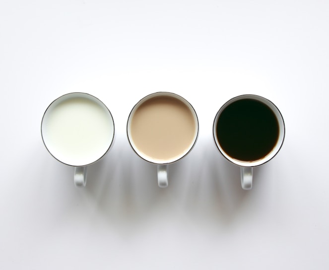 three cups of coffee sitting next to each other