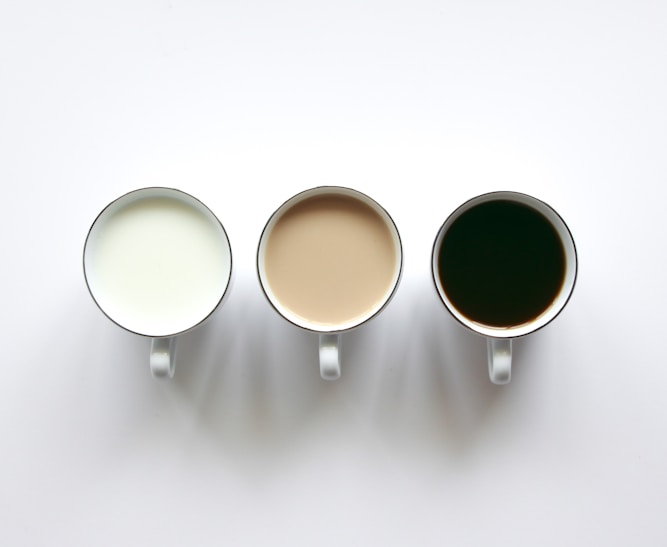 three cups of coffee sitting next to each other