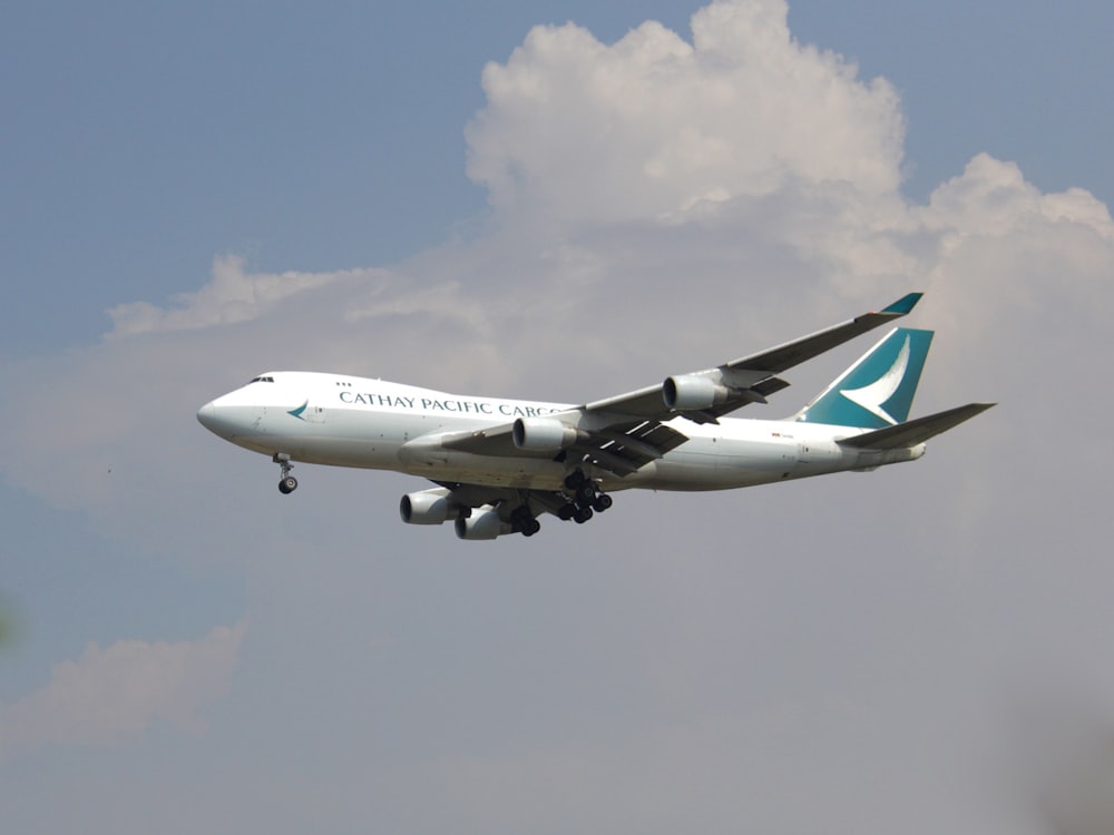 a large jetliner flying through a cloudy blue sky