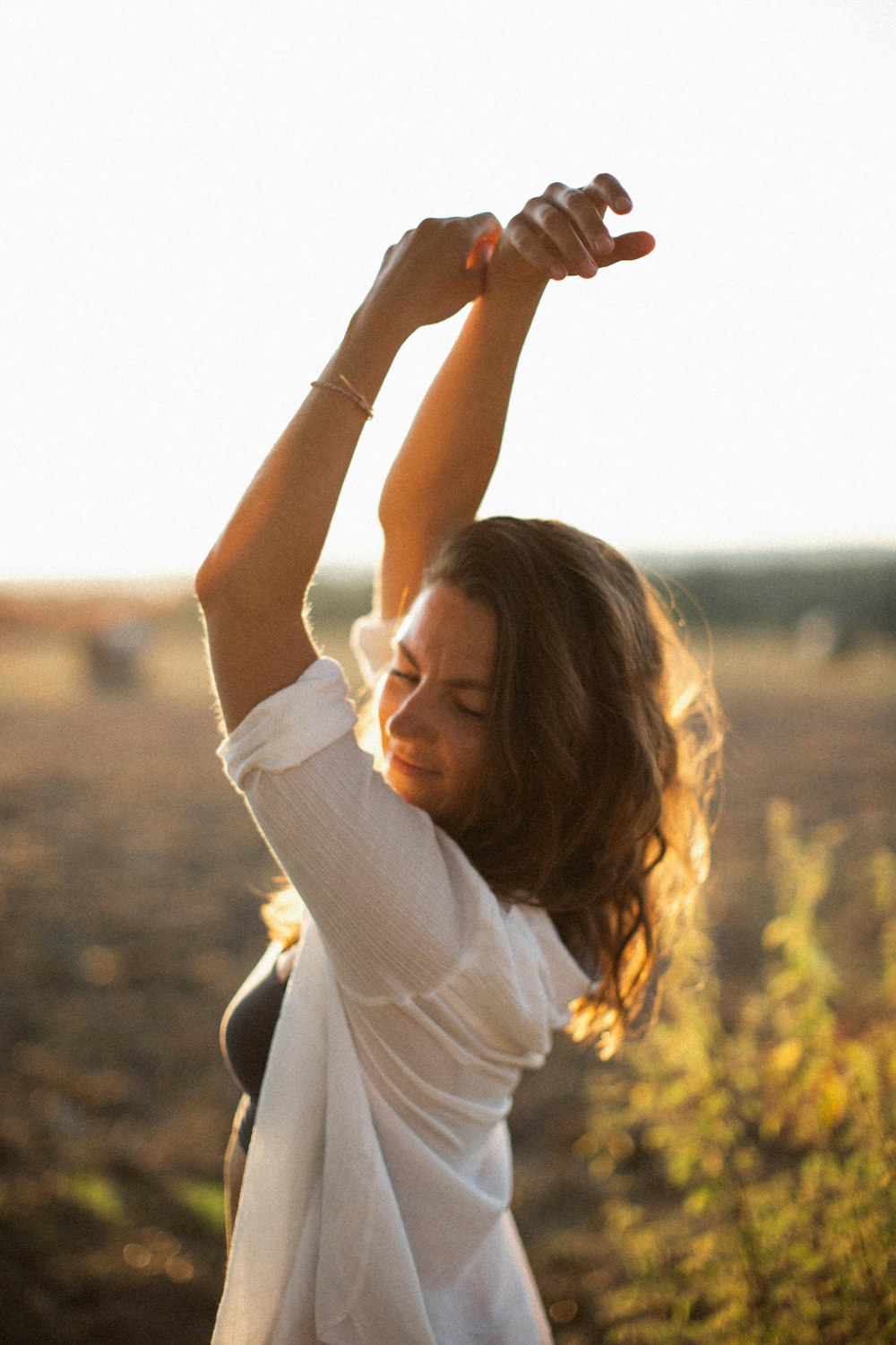 a woman stretching her arms in the air