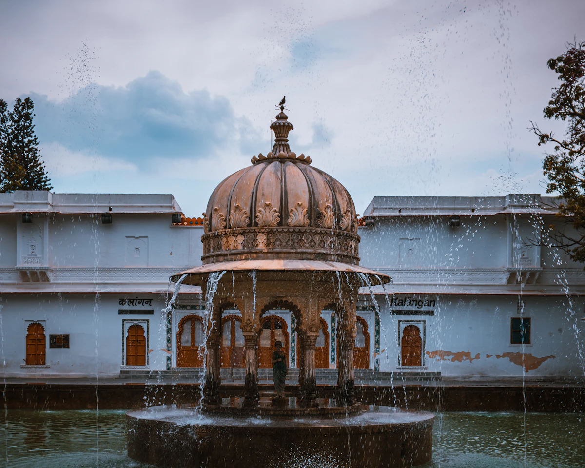 A fountain in front of a garden pavilion