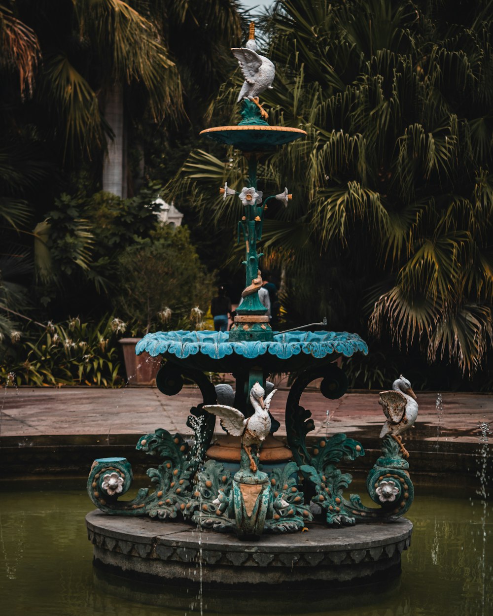 a fountain with birds on top of it