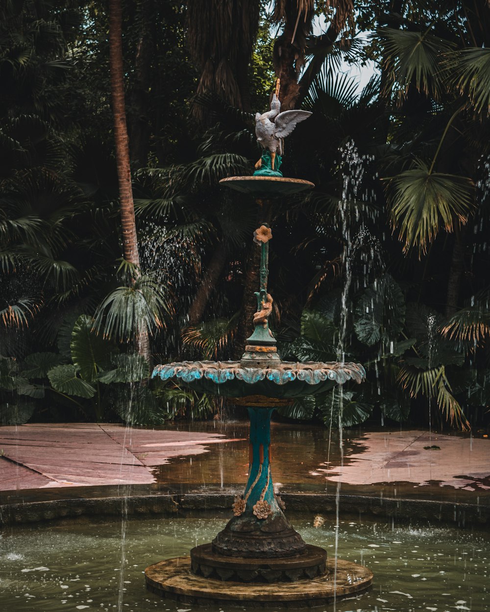 a fountain with a bird sitting on top of it