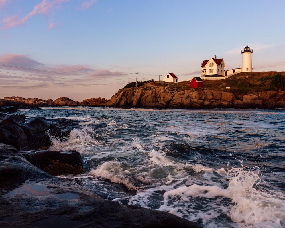 a light house sitting on top of a rocky shore