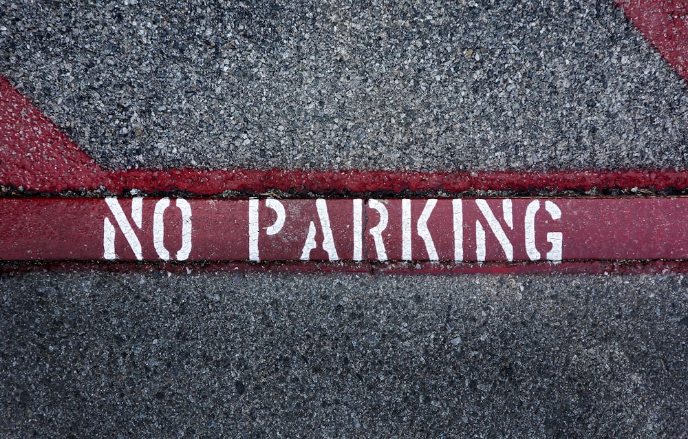 a no parking sign on the side of a road