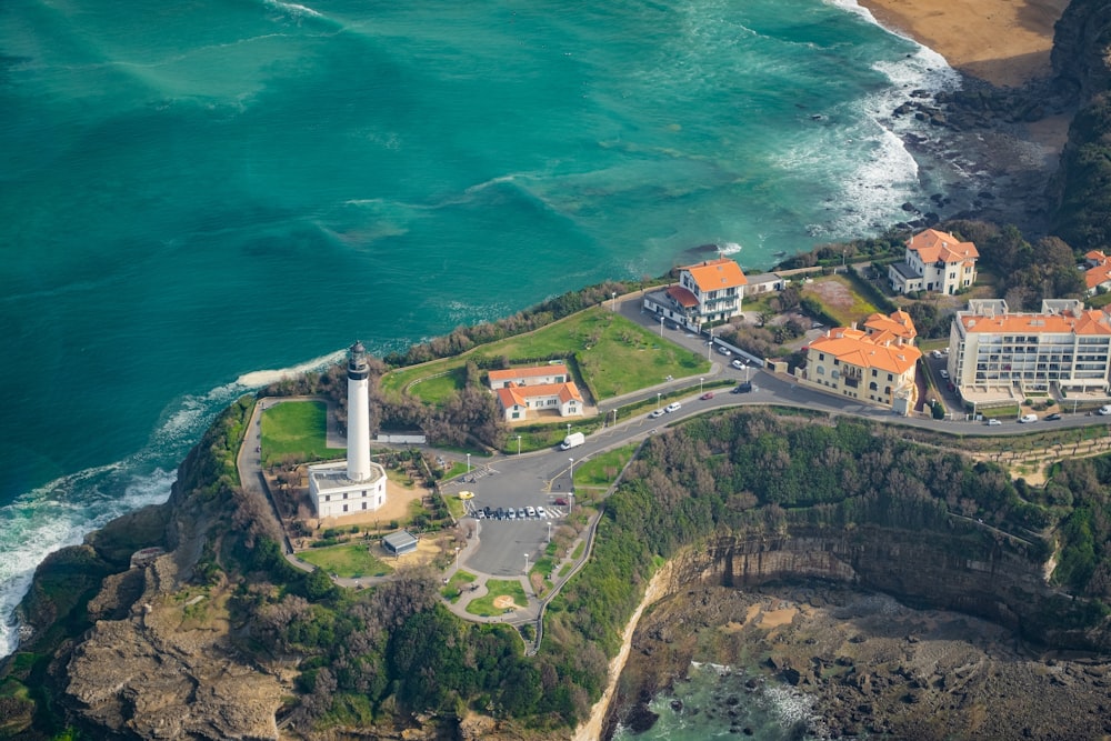 an aerial view of an island with a lighthouse