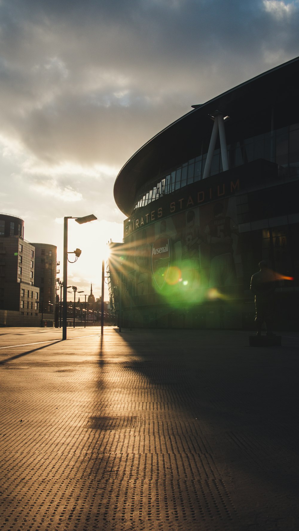 the sun is shining through the clouds over a building