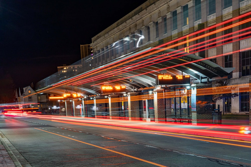 a city street at night with lights streaking by