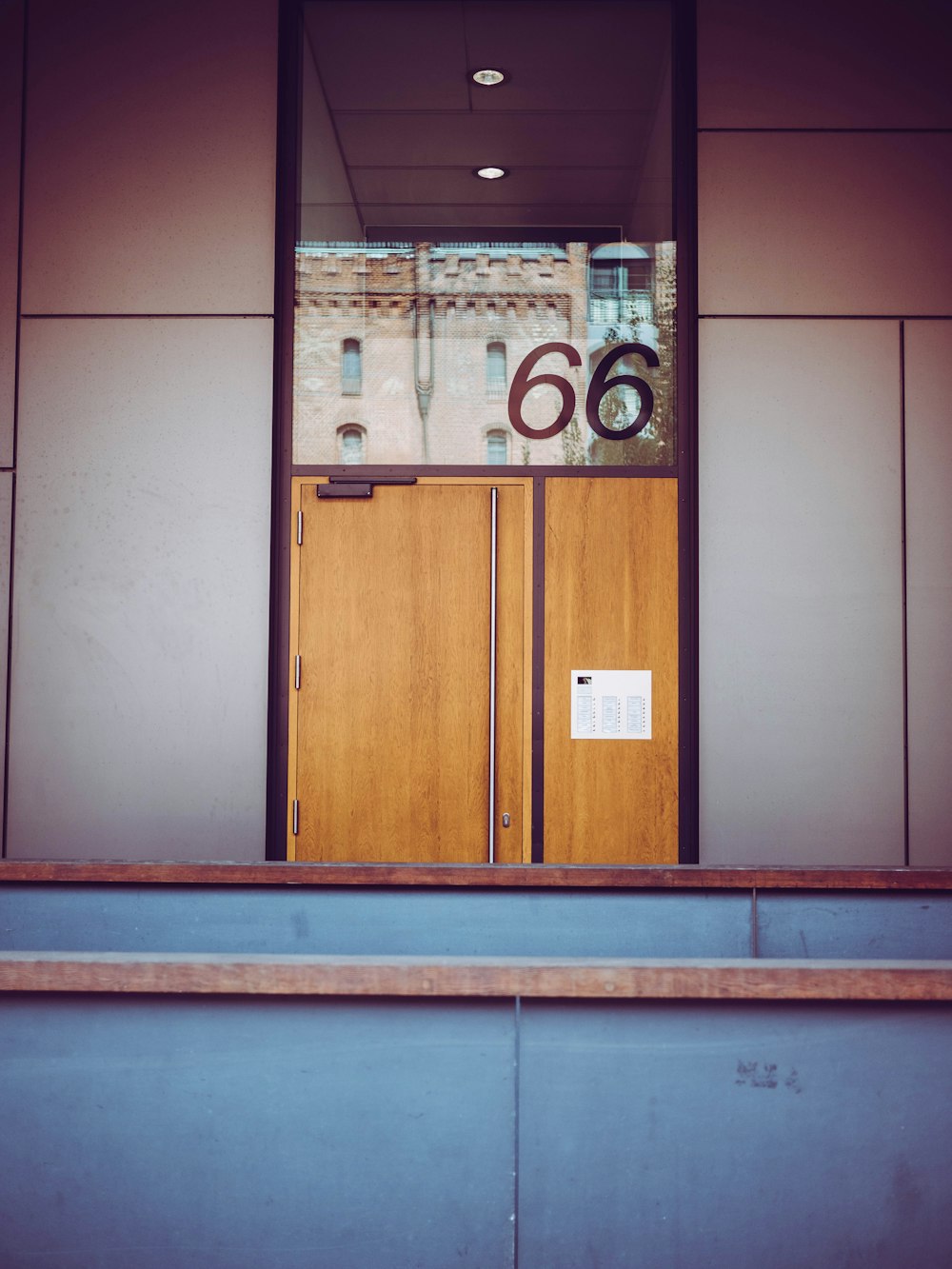 a large wooden door with a sign on it