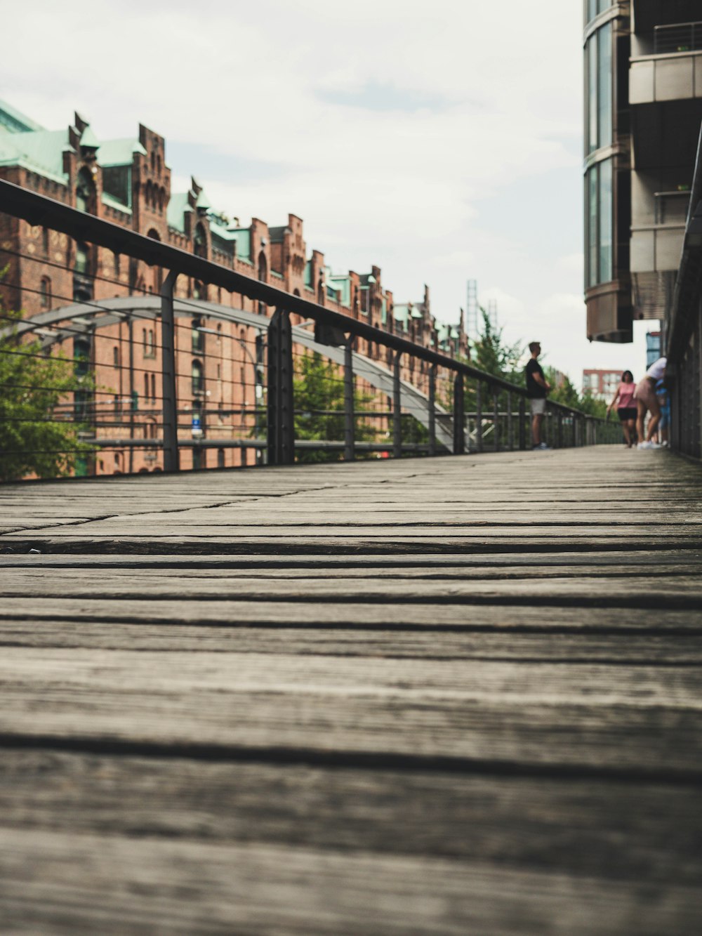 a person riding a skateboard down a wooden walkway