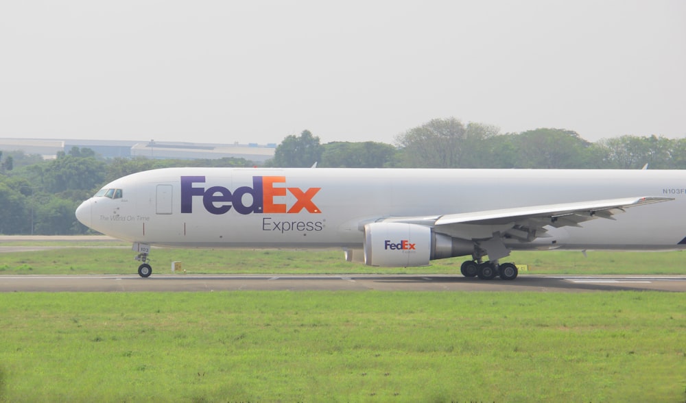 a fed ex airplane is on the runway