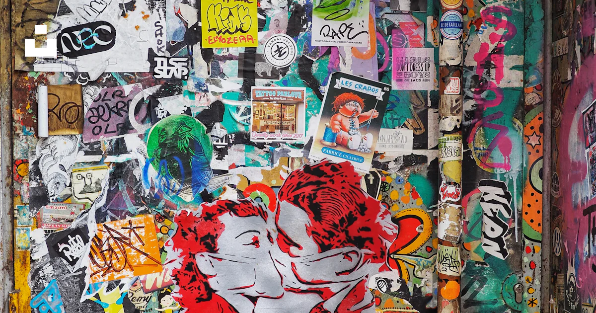 A wall covered in lots of stickers and stickers photo – Free ...