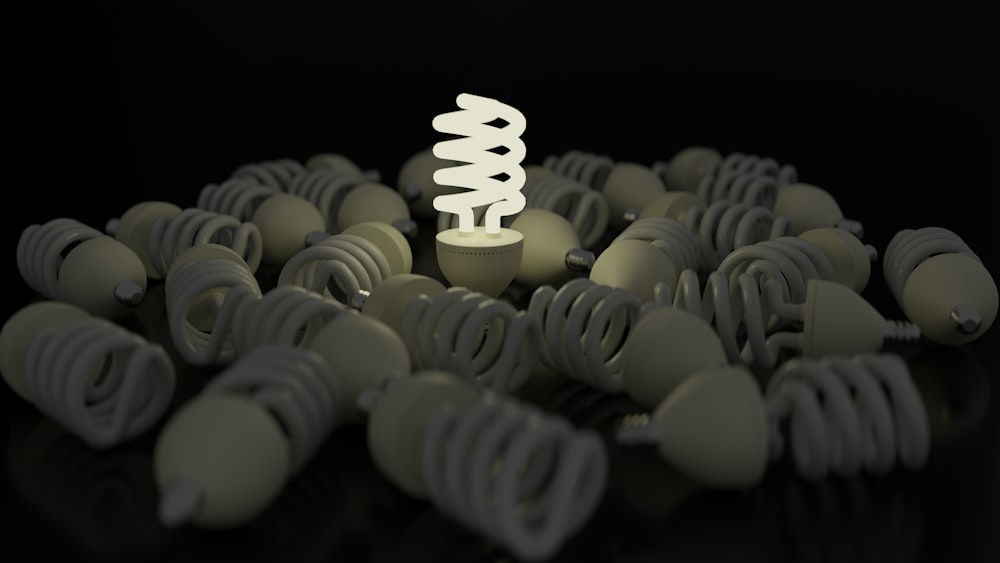 a white light bulb surrounded by many gray objects