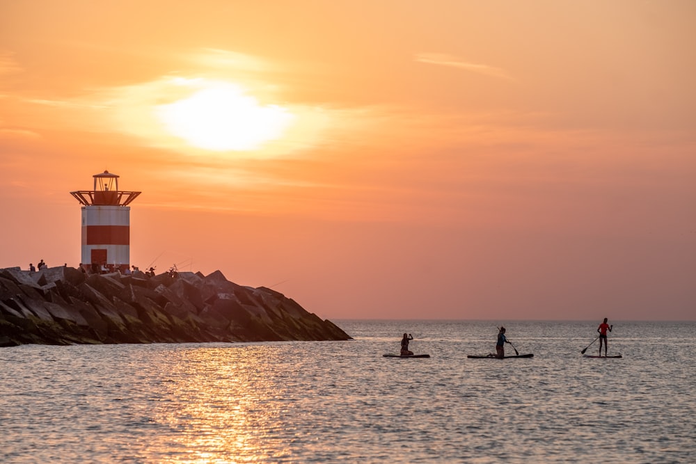 a group of people riding paddle boards on top of a body of water