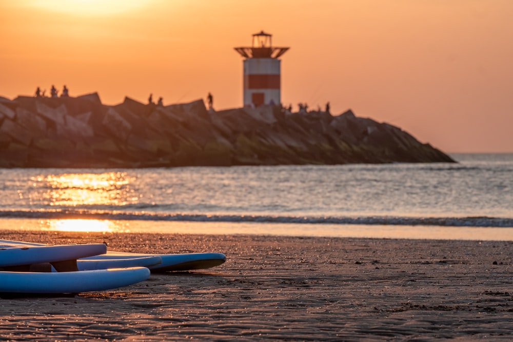 a couple of surfboards sitting on top of a sandy beach