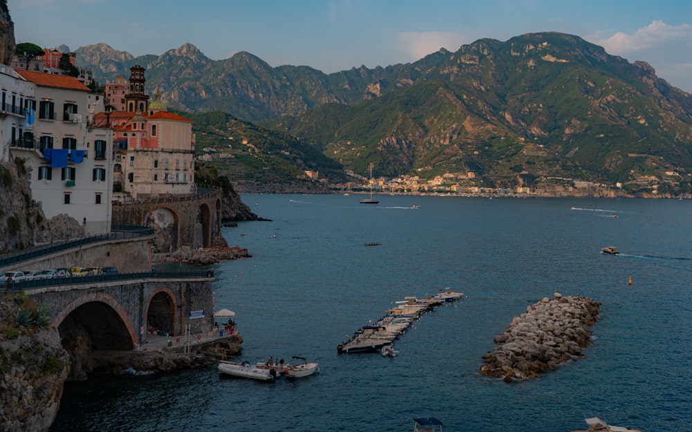 a body of water surrounded by mountains and buildings