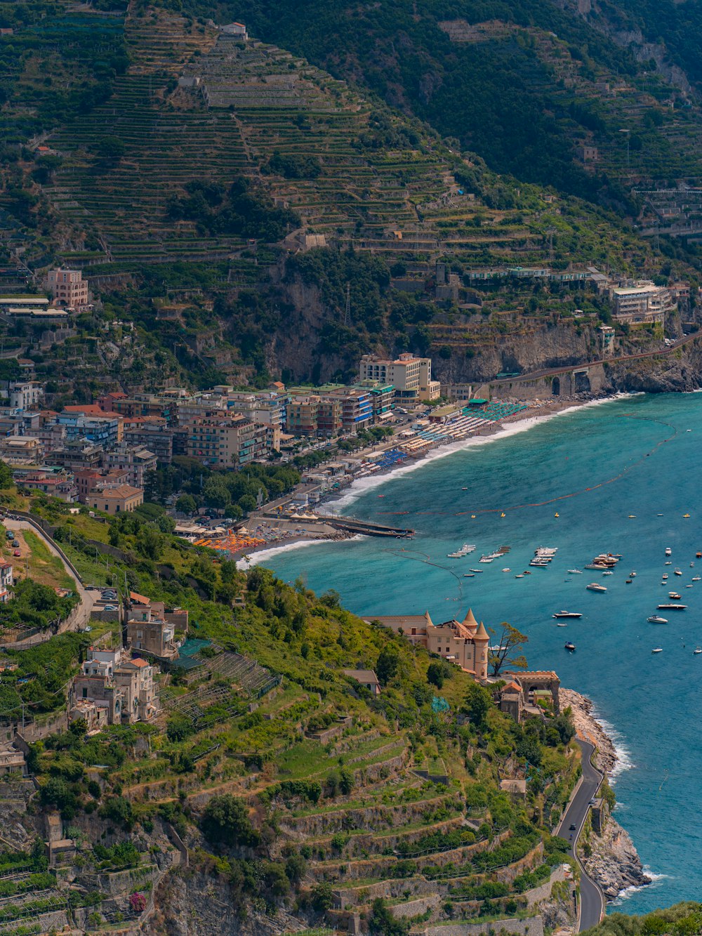 a scenic view of a beach with boats in the water