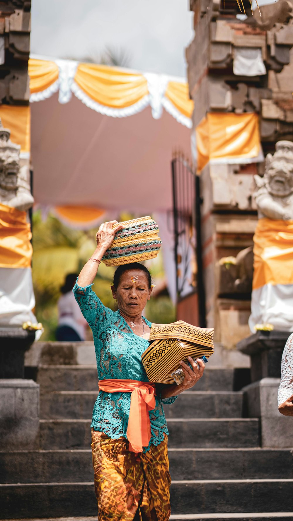 a woman carrying a basket on her head