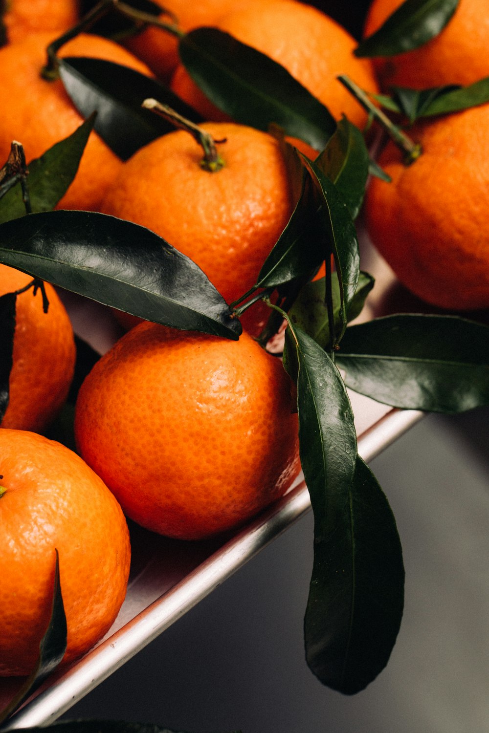 a bowl of oranges on a table